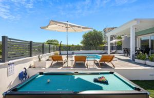 a pool table on a patio with an umbrella at Stunning Home In Krusevo in Kruševo +32 photos