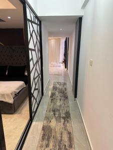 a hallway with a mirror and a bed and a rug at S 22 Marina City in Port Ghalib +12 photos