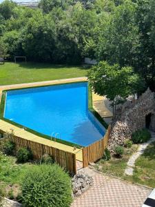 a large swimming pool with a wooden fence around it at TOURIST HOTEL in Shymkent
