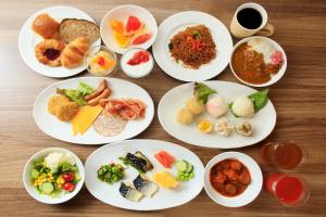 a group of plates of food on a wooden table at Richmond Hotel Yokohama Ekimae in Yokohama +119 photos