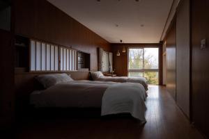 Postel nebo postele na pokoji v ubytování Villa TEN ZAN - 岐阜 ヴィラ テンザン -