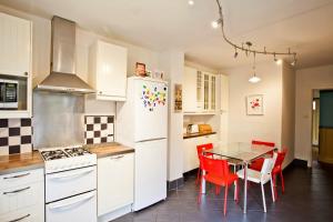 a kitchen with a table and a white refrigerator at Holiday Home York in York