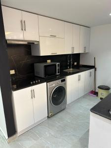 a kitchen with a washing machine and a microwave at S 22 Marina City in Port Ghalib