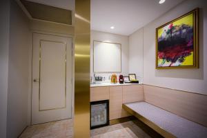 a bathroom with a bench and a fire place at Resorts World Sentosa - Crockfords Tower in Singapore