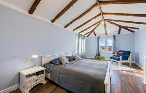 a bedroom with a bed and a blue wall at Terracotta in Zaboric