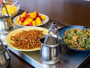a table with plates of food and bowls of fruit at Kiso Mikawaya in Kiso