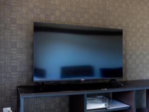 a flat screen tv sitting on top of a table at Kiso Mikawaya in Kiso