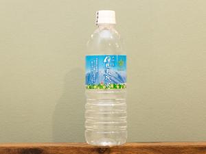 a bottle of water sitting on top of a table at Kiso Mikawaya in Kiso