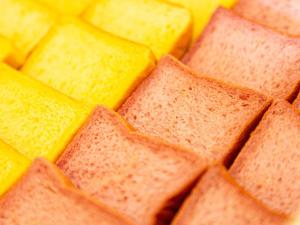 a pile of yellow and orange crackers at Kiso Mikawaya in Kiso