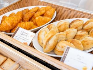 a tray with plates of bread and bowls of food at Kiso Mikawaya in Kiso