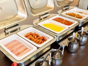 a buffet with trays of food on a table at Kiso Mikawaya in Kiso