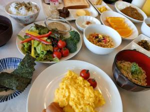 a table with plates of food and bowls of food at Kiso Mikawaya in Kiso