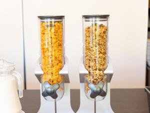 two tall glass vases filled with popcorn on a table at Kiso Mikawaya in Kiso