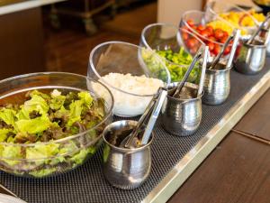 a buffet with bowls of food on a table at Kiso Mikawaya in Kiso