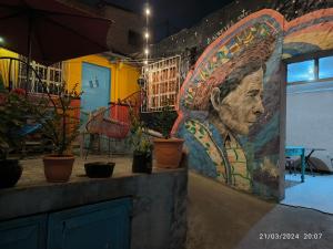 a mural of a woman on the side of a wall at Hostal Choja in Quetzaltenango +75 photos