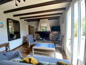 a living room with a couch and a table at Maison spacieuse à Macaye, au calme, 6-8 pers, proche Cambo, animaux admis, jardin, internet WiFi - FR-1-495-141 in Macaye
