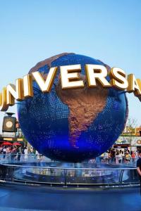a sign for the entrance to the universal theme park at Happy Dragon Universal Vacation Hotel - close to Universal Studio and Wanda Plaza,free shuttle to the Resort,Free Coffee,Laundry in Beijing