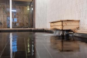 a building with water coming out of a wooden box at Kiso Mikawaya in Kiso
