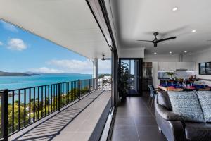 a balcony with a view of the ocean at Panorama at Shute Harbour in Shute Harbour +17 photos