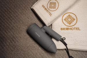 a wireless router sitting on the floor next to a towel at Tanimachi Namba East43 in Osaka