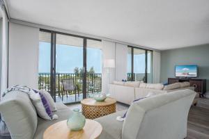 a living room with white furniture and large windows at Our House at the Beach W-Tower 5th Fl in Siesta Key