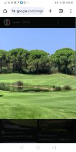 a screenshot of a webpage of a golf course at Torre del Pozzo Seaview Retreat Sunset Terrace in S'archittu Cuglieri