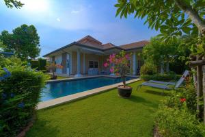 a house with a swimming pool in a yard at Modern 3 Bedroom Pool Villa - MR54 in Hua Hin