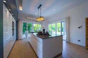 a large kitchen with a island in a house at Modern 3 Bedroom Pool Villa - MR54 in Hua Hin