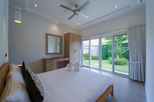 a bedroom with a large bed and a large window at Modern 3 Bedroom Pool Villa - MR54 in Hua Hin +56 photos