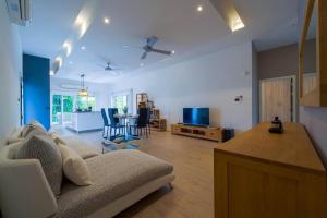 a living room with a couch and a table at Modern 3 Bedroom Pool Villa - MR54 in Hua Hin