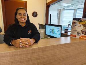 a woman sitting at a counter in an office at Sky Osorno Centro in Osorno