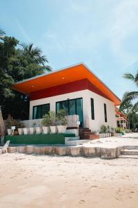 a house with an orange roof on the beach at JP Resort Koh Tao in Koh Tao
