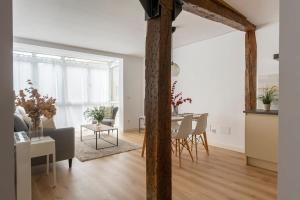 a living room with a table and a dining room at New apartment in the heart of the center in Santander +13 photos