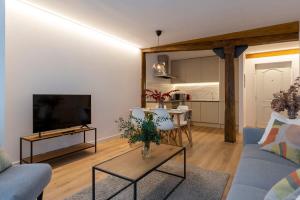 a living room with a blue couch and a table at New apartment in the heart of the center in Santander