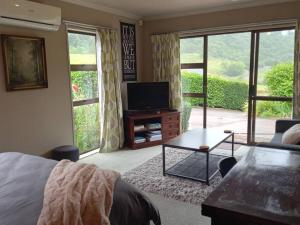a living room with a bed and a tv at Rural life in Otorohanga