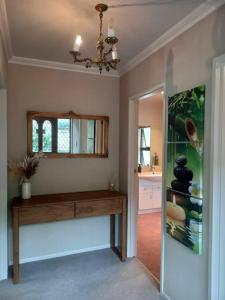 a room with a table and a mirror and a window at Rural life in Otorohanga +32 photos