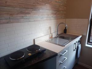 a kitchen with a stove top and a sink at Rural life in Otorohanga