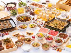 a table filled with lots of different types of food at Vessel Inn Shinsaibashi in Osaka