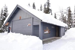 a small blue building with snow around it at Aikku cabin in the heart of Lapland, free Lapin Kota, Budget week in Ylläs