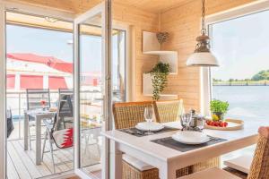 a kitchen with a table and chairs and a balcony at Lewisia in Barth