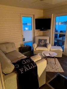 a living room with a couch and a table at Snowbird in Lübeck