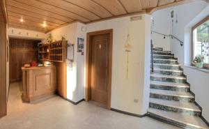 a staircase in a house with a wooden ceiling at Pension Obertaberhof in Schenna