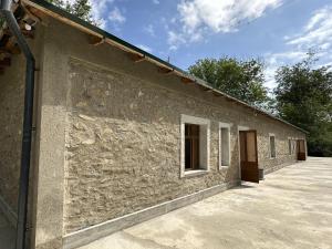 a stone wall of a building with a window at MusoBarakaNur Guest House in Yukary-Ukhum