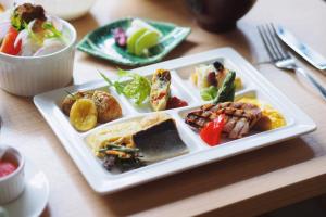 a white plate of food on a table at Hotel Intergate Kyoto Shijo Shinmachi in Kyoto