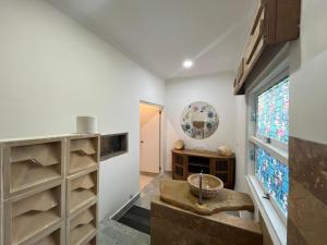 a hallway with a room with a window and shelves at Lavender star house in Kuta