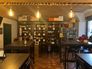 a bar with tables and chairs in a room at Residenza Il Castello Uno e Due in CastellʼArquato