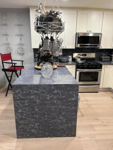 a kitchen with a black counter top in a room at A Luxury Master Bedroom in a Condo in Los Angeles