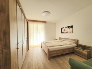 a bedroom with a bed and a large window at Urlaub auf dem Bauernhof Schmidhof - große Terrasse, Pool und beste Lage in Caldaro +27 photos