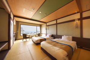 A bed or beds in a room at Umiusagi