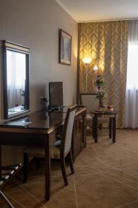 a room with a desk and a table and chairs at Hotel Aquastar Danube in Kladovo +72 photos